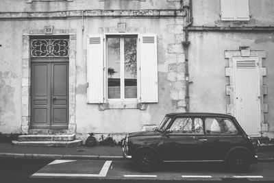 Old building by street in city