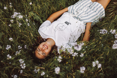 Young woman lying on field