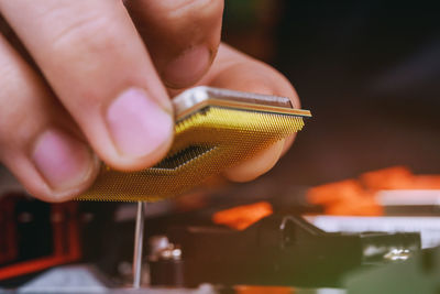 Close-up of hand holding computer chip