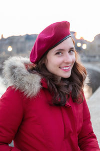 Portrait of smiling woman wearing hat during winter