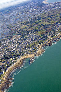 High angle view of sea and cityscape against sky