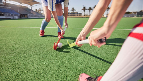 Low section of man playing soccer on field