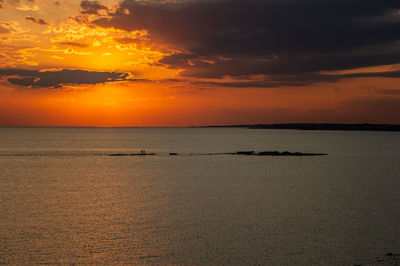 Scenic view of sea against orange sky