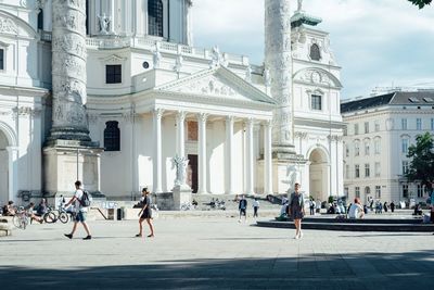 People in front of church against sky in city