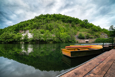 Scenic view of lake by trees against sky