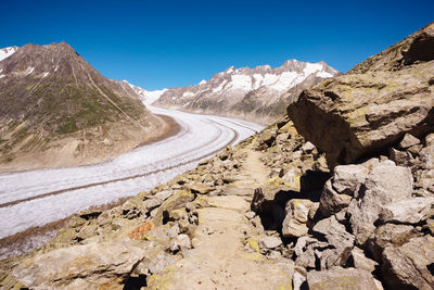 Scenic view of mountains against clear blue sky