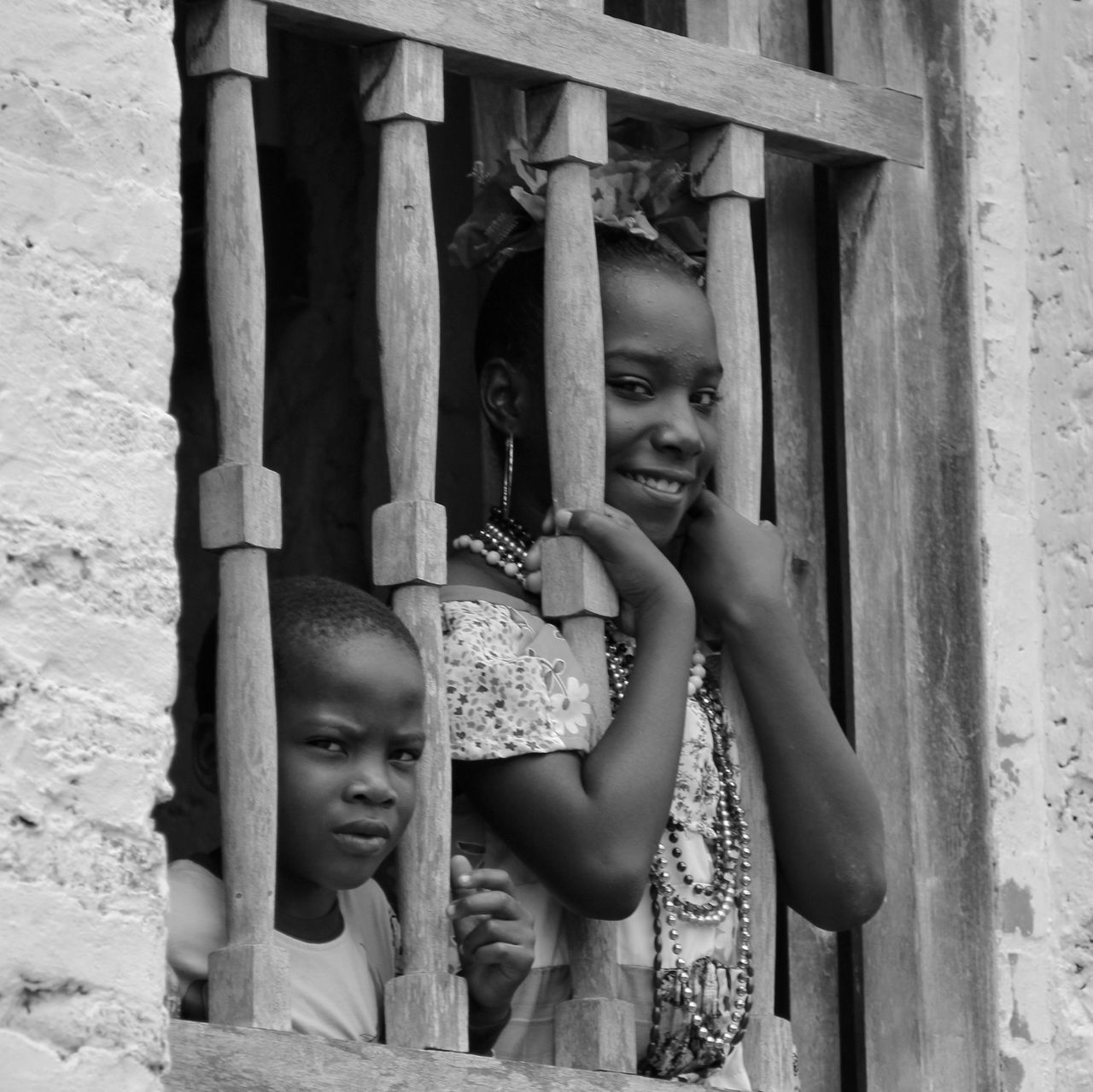 front view, childhood, lifestyles, built structure, indoors, art, human representation, day, architecture, leisure activity, art and craft, door, wood - material, creativity, standing, holding, wall - building feature