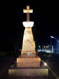 Illuminated sculpture against building at night