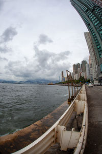 View of bridge over sea against cloudy sky