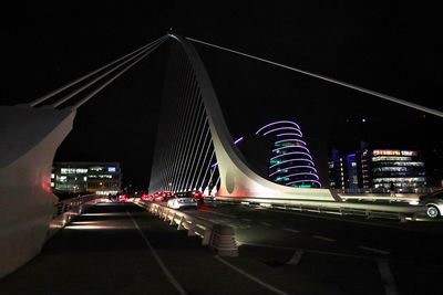 Light trails on road against sky at night