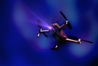 A flying drone. airborne quadcopter. also known as a drone or uav.