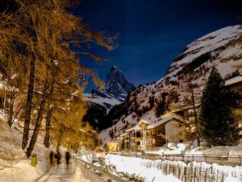 Panoramic view of snow covered mountain against sky at night