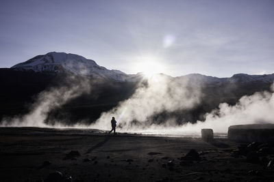 Man walking on ground against sky