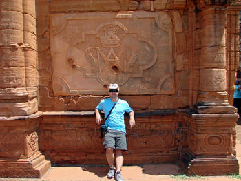 Full length of man standing by old ruins at san ignacio mini