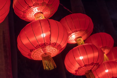 Low angle view of illuminated chinese lanterns hanging at night