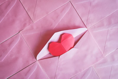 Full frame shot of pink envelopes with heart shape