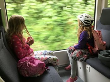 Girl traveling with sister in train