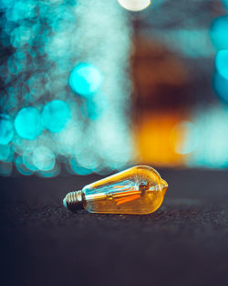 Close-up of illuminated bottle on table