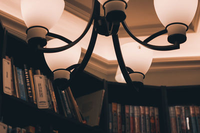 Low angle view of illuminated lamp on ceiling