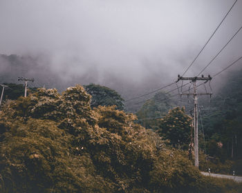 Low angle view of electricity pylon against sky