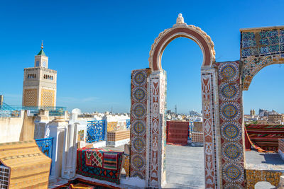 Mosque against clear blue sky in city