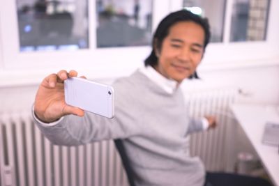 Portrait of young woman using mobile phone