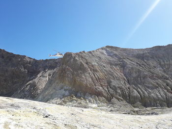 Scenic view of mountains against clear blue sky