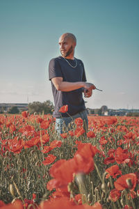 Full length of man standing on field against sky