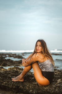 Woman sitting on a rock