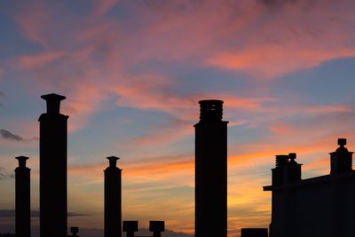 Low angle view of silhouette building against sky during sunset