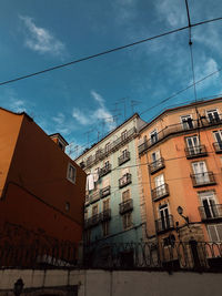 Low angle view of buildings against blue sky