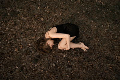 High angle view of woman lying on land