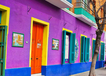 Multi colored houses on street against building