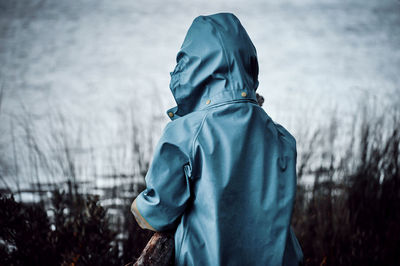 Rear view of man standing in rain