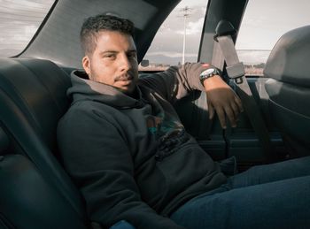 Portrait of man sitting in car