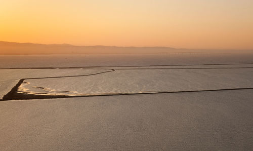 Scenic view of sea against clear sky during sunset