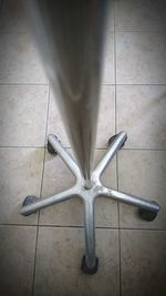 Low section of person standing on tiled floor at home