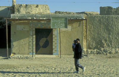 Rear view of young woman standing on beach