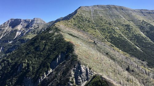 Low angle view of mountain range against clear sky