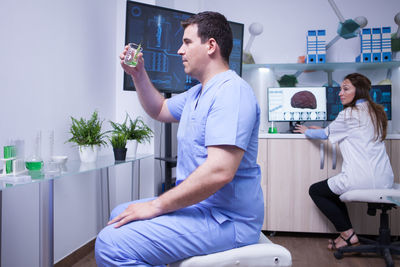 Side view of doctor examining patient at home