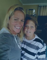 Portrait of happy mother with daughter standing on floor