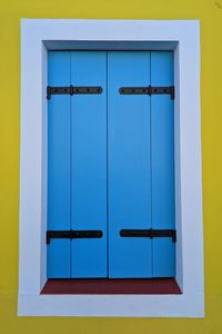 Blue shutter, yellow wall