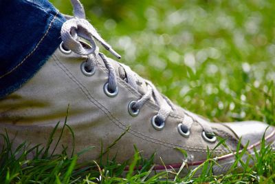 Low section of a high angle view of shoes on field