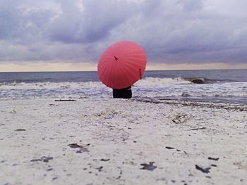 Boy on beach against sky