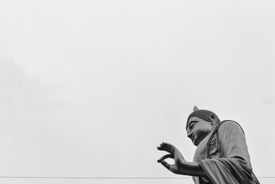 Low angle view of woman against clear sky