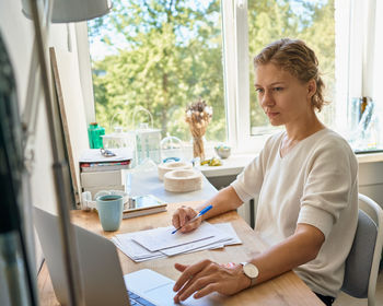 Woman holding coffee cup on table