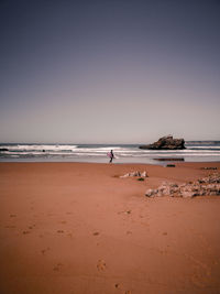 Scenic view of beach against clear sky