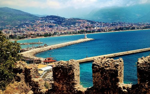 High angle view of sea with buildings in background