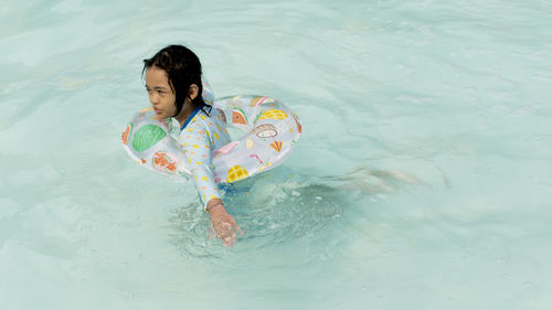 Portraits of asian girl wearing a swimsuit. swimming in the pool