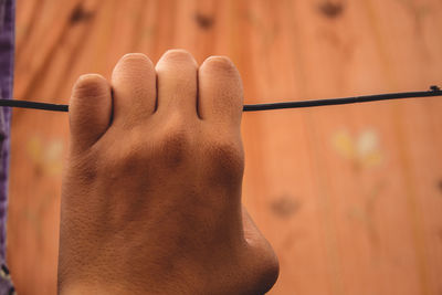 Close-up of hand holding cable